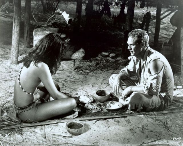 Ratna Assan (as Zoraima) and McQueen (as Papillon).